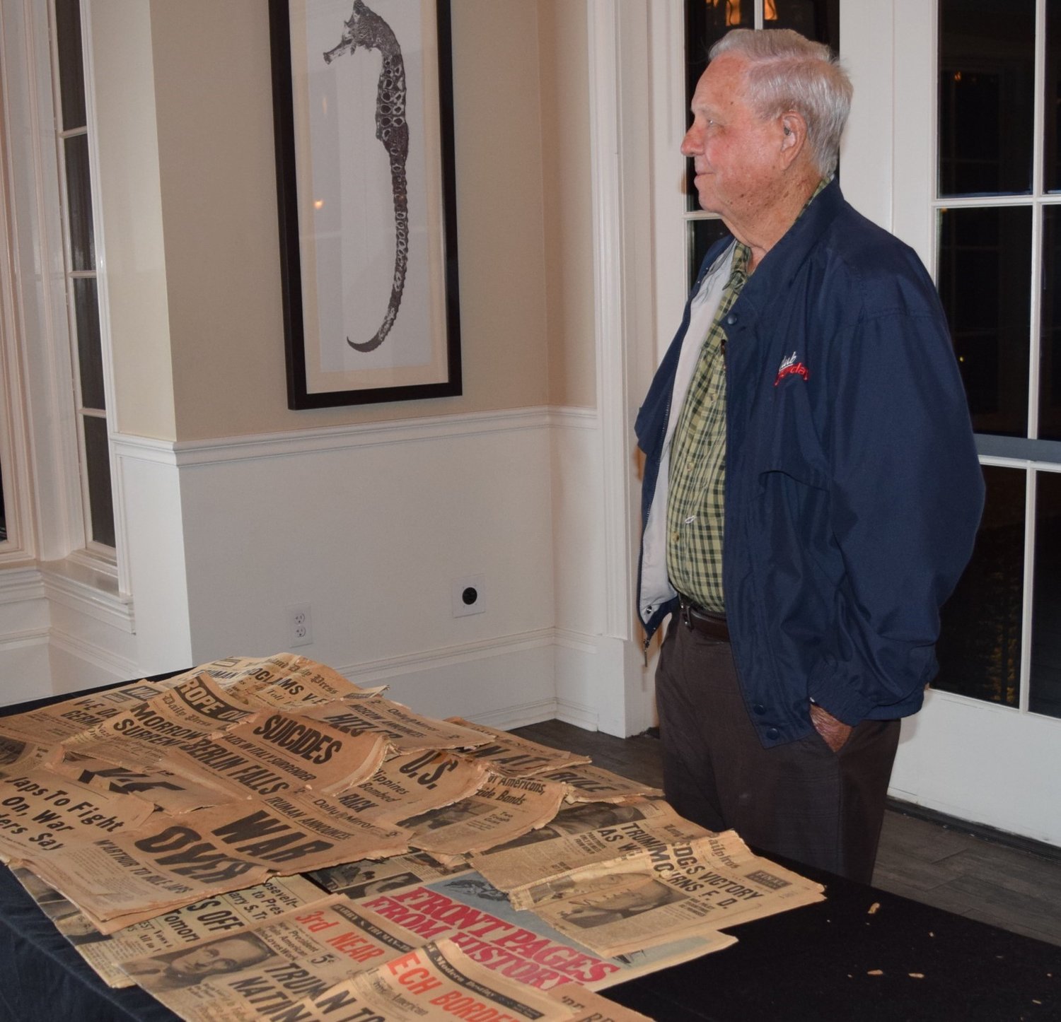 Don Prince, a veteran who fought in Korea, brought a footlocker full of original newspapers from World War II for guests to view.